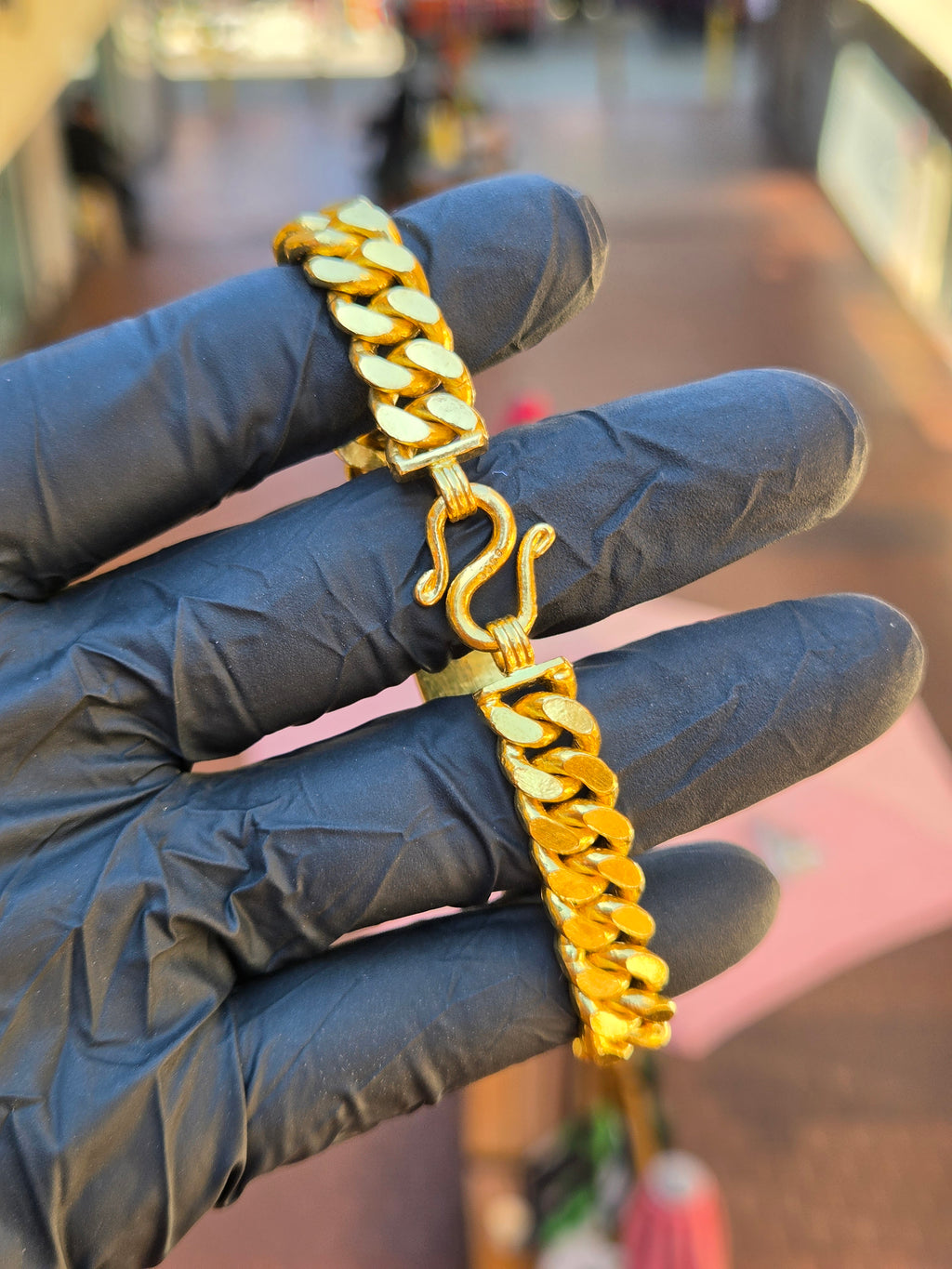 S-hook clasp of the 10.5MM Tri-ID bracelet open, the Cuban link running away on both sides