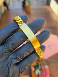 The 11MM engravable ID bracelet laid across the fingers, its blank polished plate set into the Cuban link