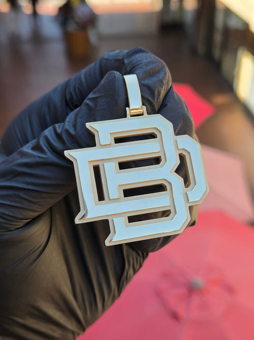Solid gold BD interlocked monogram pendant, varsity block letters with mirror-polished faces, matte recessed outlines and open through-cut counters