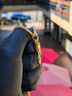 Italian Cornicello gold pendant shown at an angle, showing the faceted ridge running the length of the horn and the taper to the point