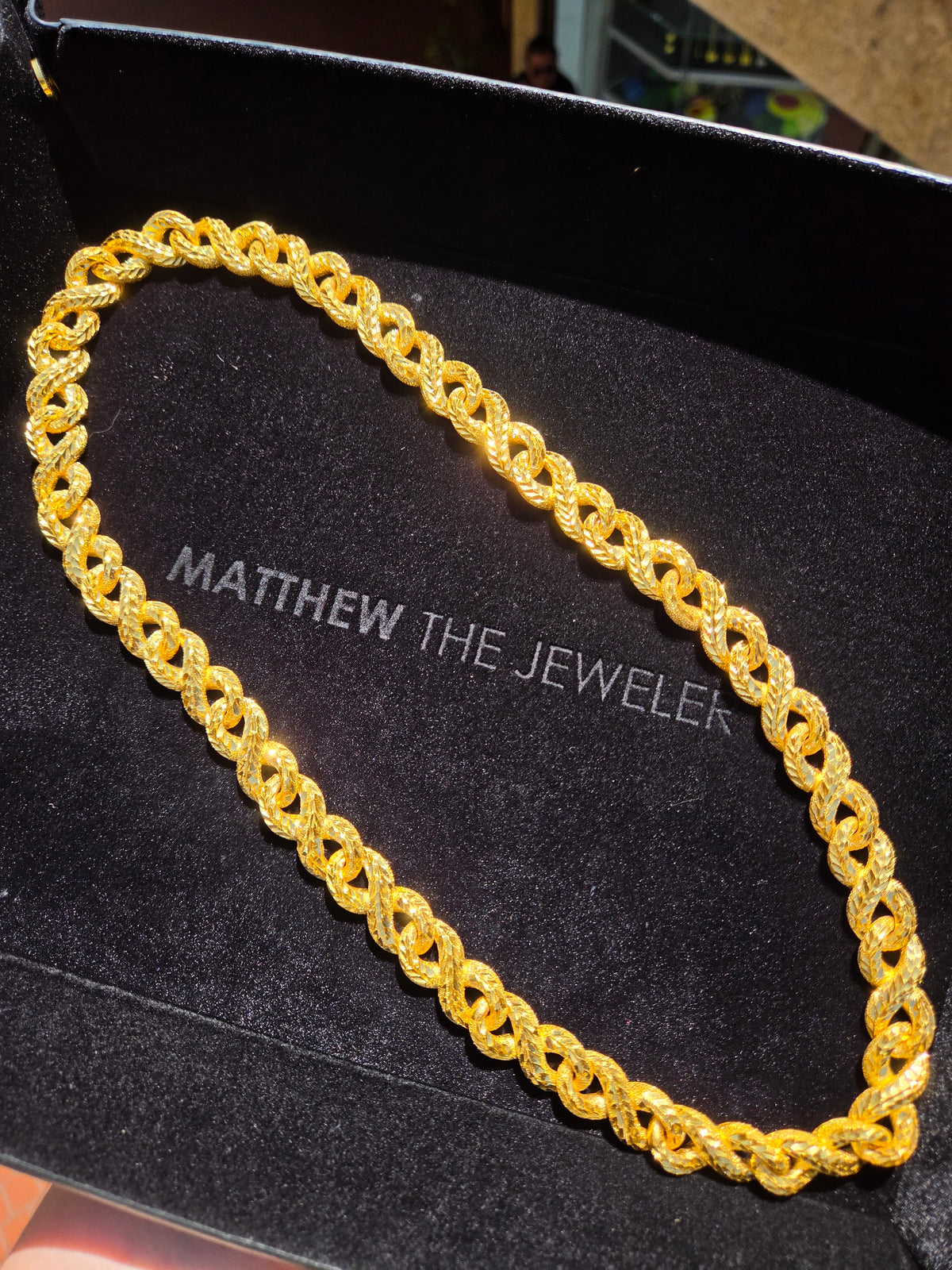 14.5MM Diamond-Cut Infinity Link Chain in solid gold, doubled figure-eight loops threaded through one another to form a continuous braid