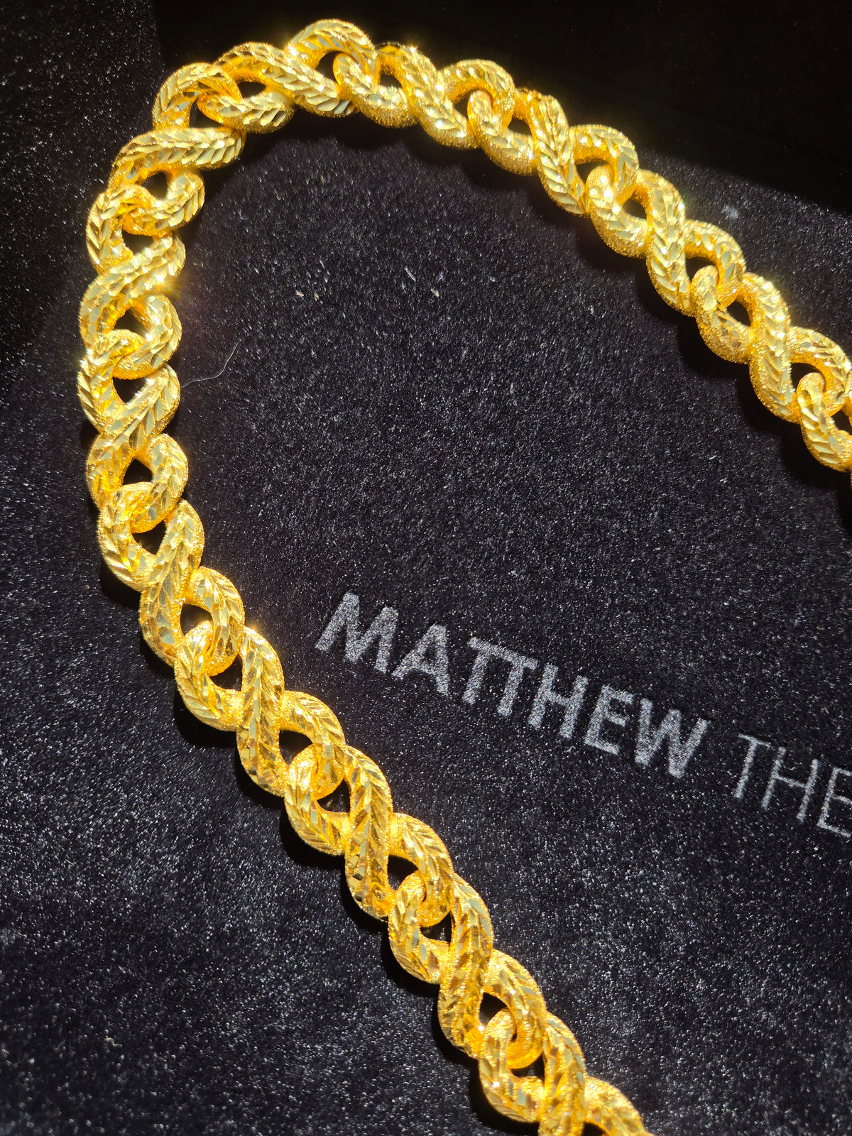 Heavyweight 14.5MM solid yellow gold infinity link chain presented in a Matthew The Jeweler box