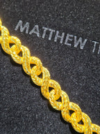 14.5MM solid gold Diamond-Cut Infinity Link Chain, the interlocking braid pattern running unbroken along its length