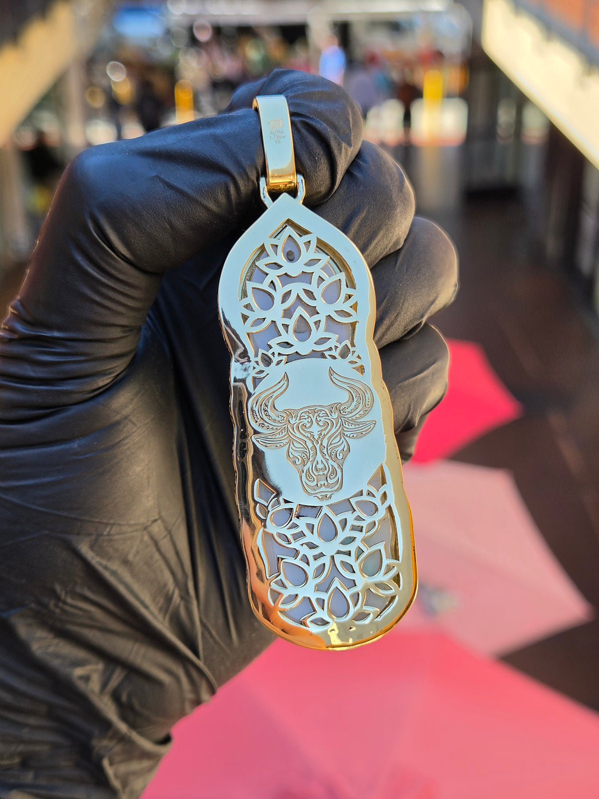 Reverse of the Jade Lady Buddha (Guan Yin) pendant, polished gold pierced with lotus openwork at top and bottom and an engraved ox head between them. The back can be made to order.
