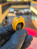Solid gold Eagle and Lion Sculpted Ring seen from the front, both animal heads carved in the round on the crown above an engraved acanthus shoulder.