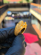 Three-quarter view of the Eagle and Lion Sculpted Ring showing the deep-cut acanthus scrollwork running down the shoulder toward the back of the shank.