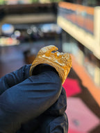 Side view of the Eagle and Lion Sculpted Ring with the eagle in profile, the hooked beak parted and the neck feathers cut in overlapping rows.