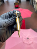 Solid gold .223 Remington rifle bullet pendant with a Latin cross rising from the case head, mirror-polished throughout