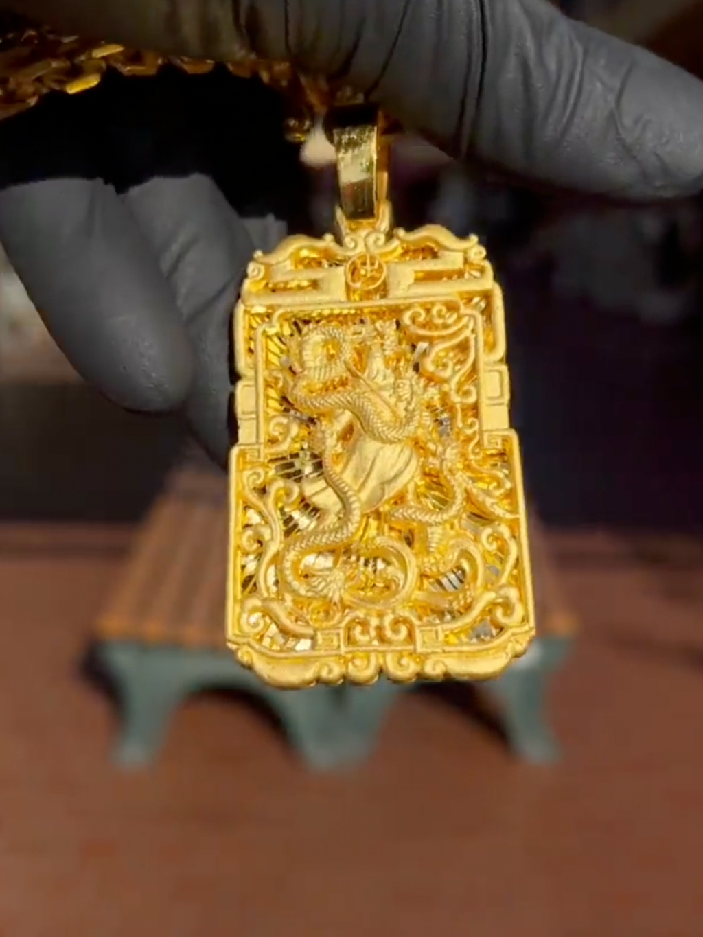 God of War and Dragon Fretwork gold pendant, close view of the 3D figure with glaive and the dragon over the shoulder