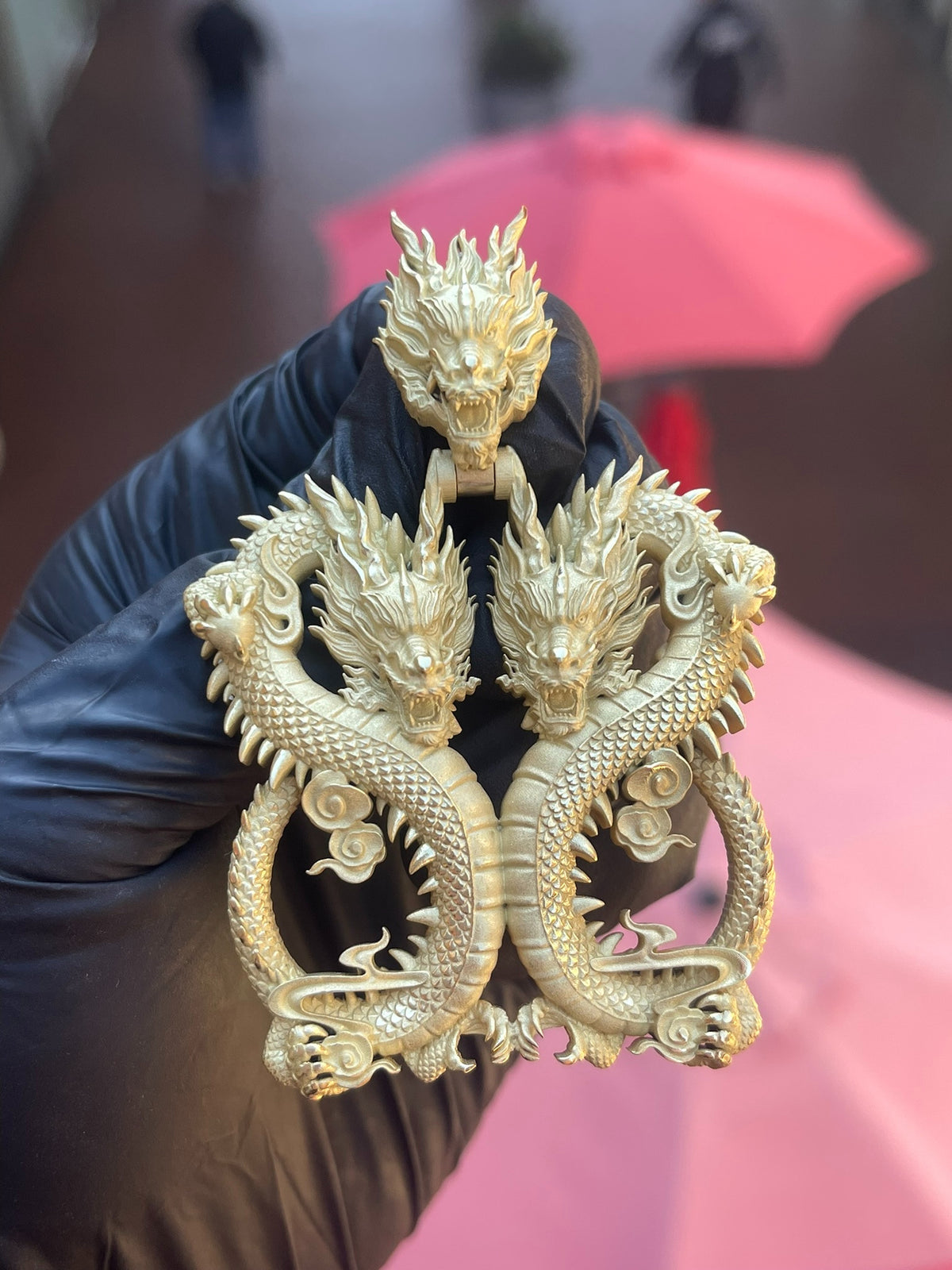Solid gold 88 Dragon Pendant, two mirrored dragons coiled into the figure 88 with a third carved dragon head forming the bail above them.