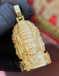 Gold Bayon face tower pendant, the Angkor Thom face carved with stone masonry joint lines