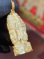 Bayon face tower gold pendant profile, second face turned to the side over kbach scrollwork