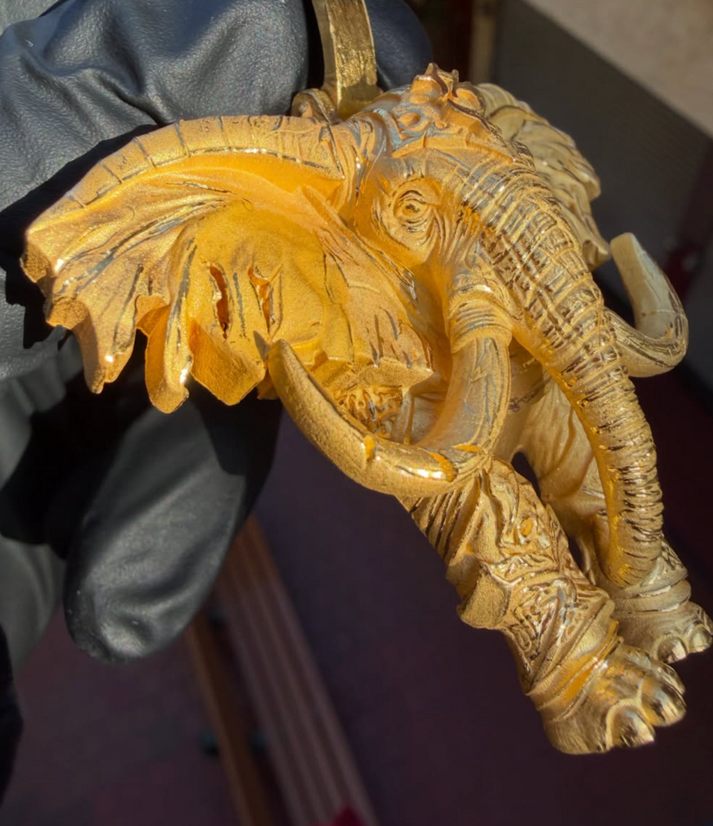 War elephant gold pendant detail, scrolled crown ornament above the brow
