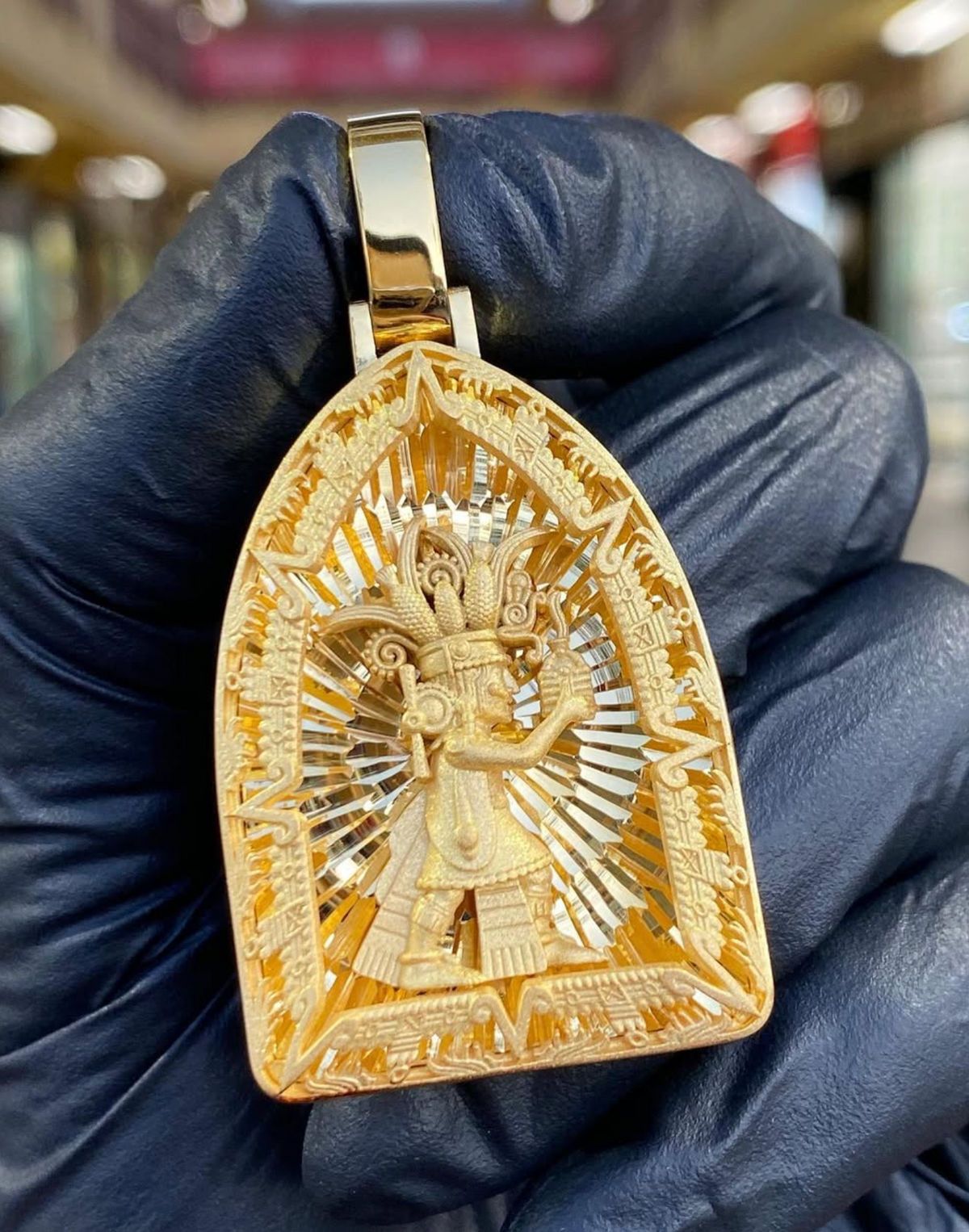 Solid gold Diamond-Cut Aztec Corn Maize Cob Lord Pendant, the maize god in an arch frame with stepped greca fretwork and a diamond-cut ray burst