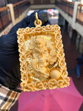 Solid gold dragon, skull and tiger pendant, three figures in a deep well on a diamond-cut ray field inside a carved cloud border
