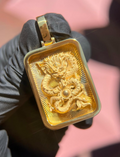 Solid gold Diamond-Cut Eternal Dragon Rectangular Pendant, coiled dragon chasing a polished pearl on a diamond-cut ray field