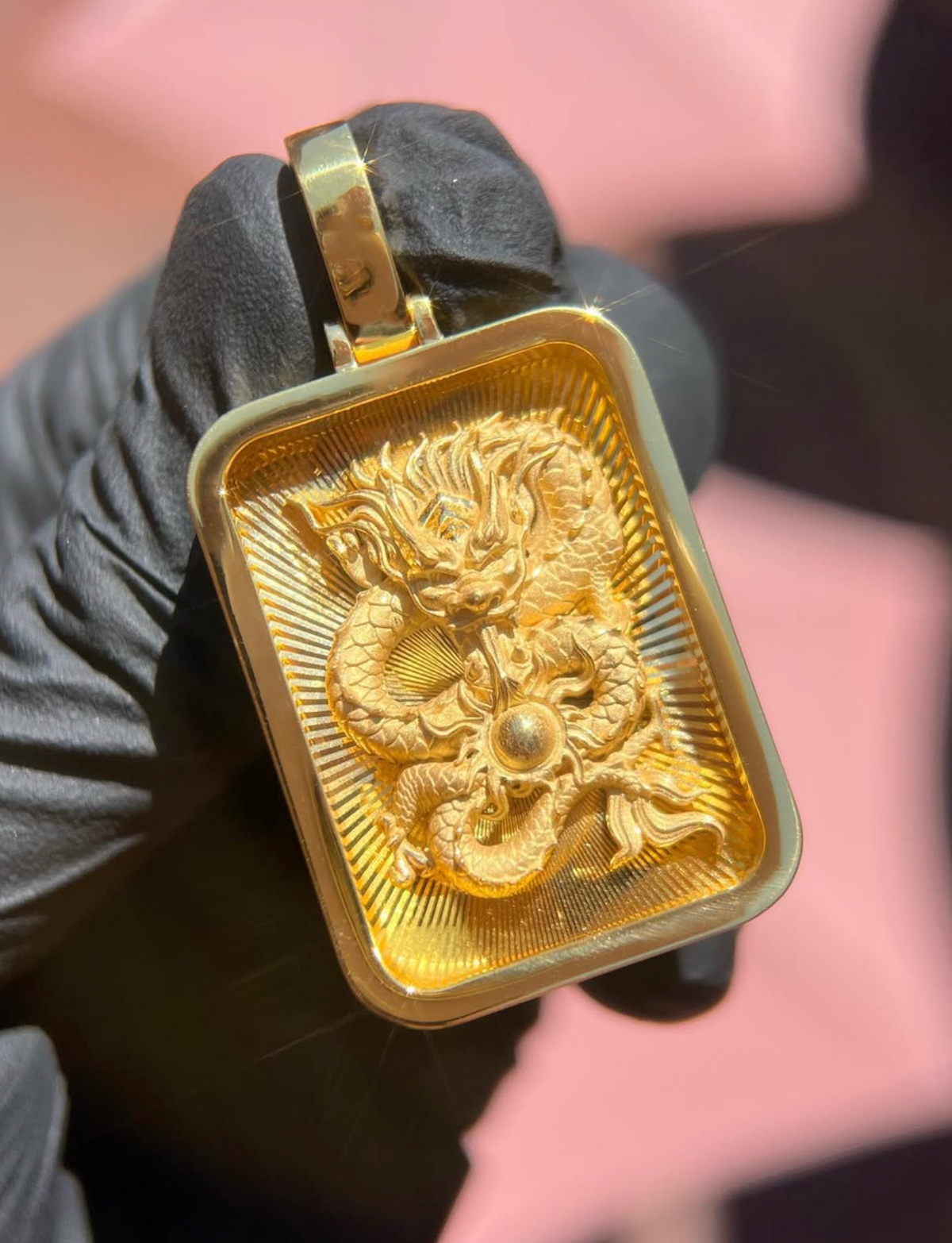 Solid gold Diamond-Cut Eternal Dragon Rectangular Pendant, coiled dragon chasing a polished pearl on a diamond-cut ray field