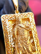 Guan Gong openwork gold pendant detail, satin figure stroking his beard against the pierced ray field
