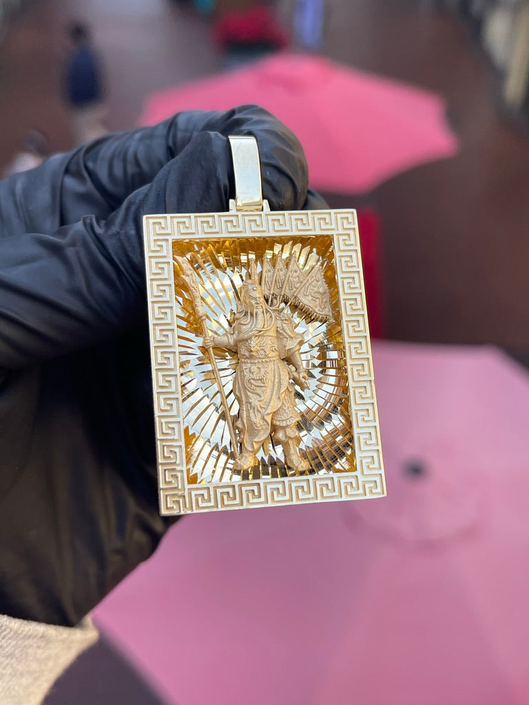 Solid gold Guan Gong rectangular pendant, the God of War recessed in a Greek key frame against a diamond-cut sunburst