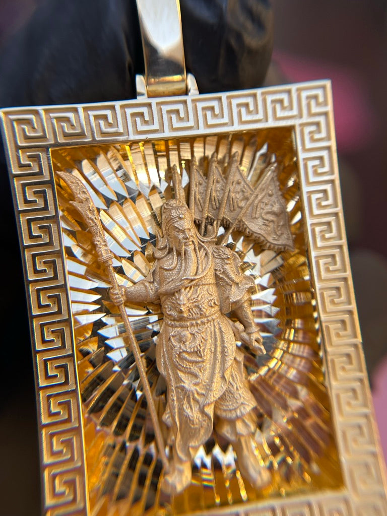 Guan Gong gold pendant detail, satin figure holding the guandao with banner pennants and dragon belly plate