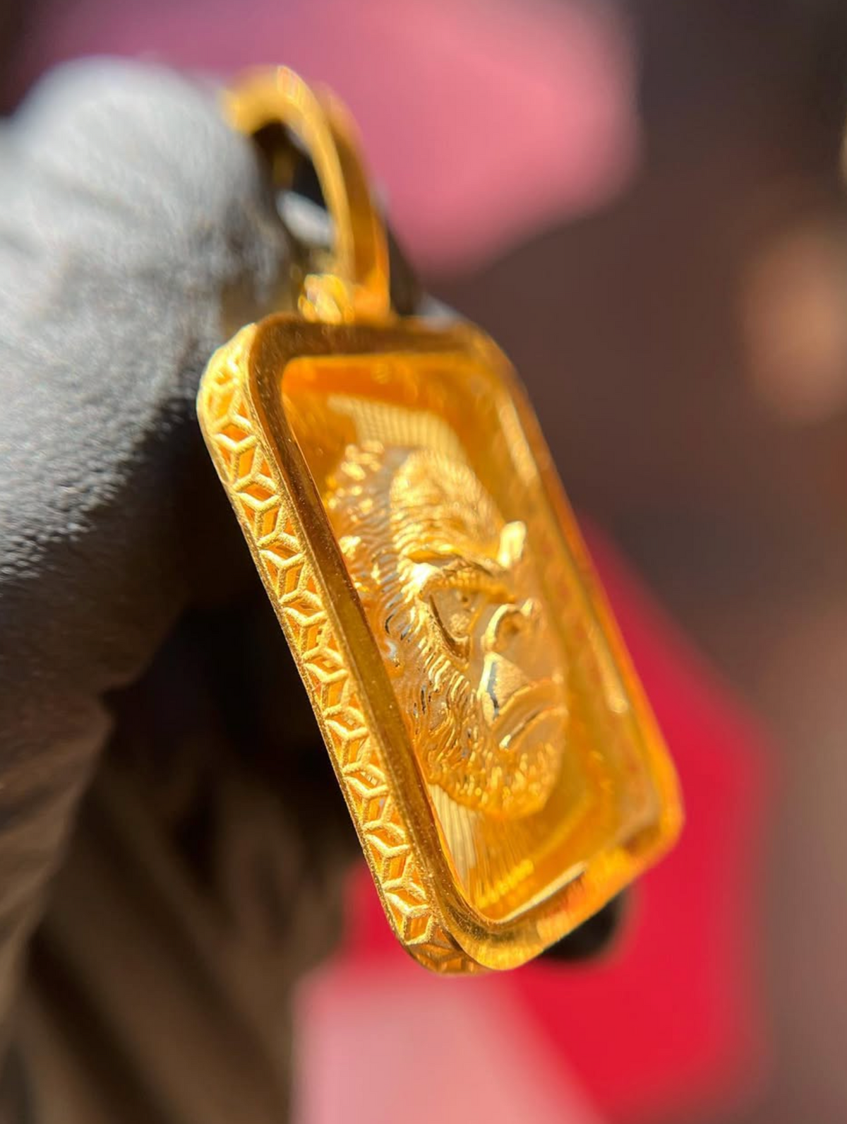 Diamond-Cut Gorilla Face Rectangular gold pendant, angled view showing relief depth and polished bail