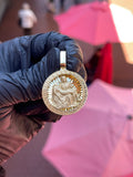 Solid gold Michelangelo Pieta circular pendant, satin figures in high relief on a diamond-cut ray field with Greek key border