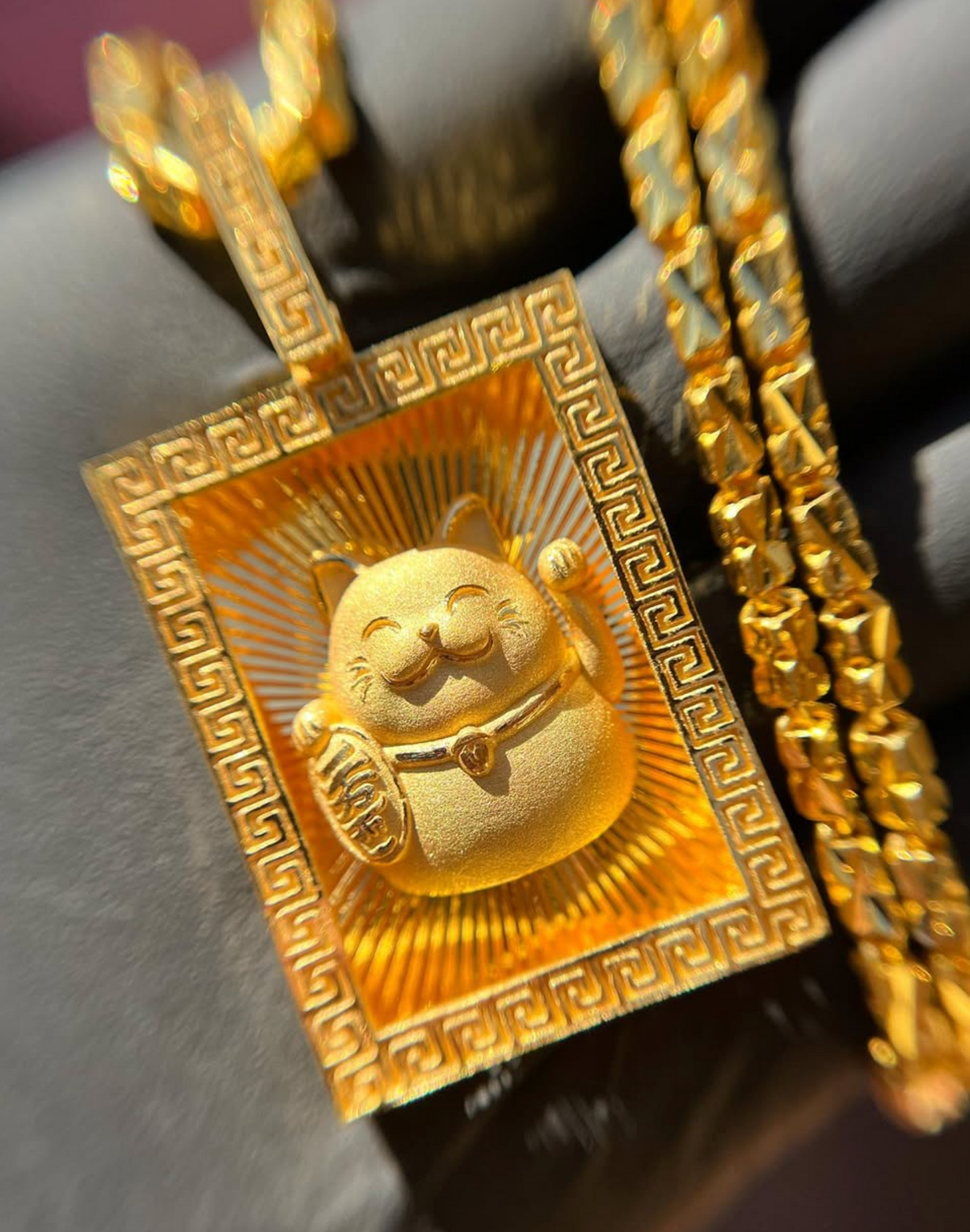 Solid gold Diamond-Cut Money Cat Rectangular Pendant with maneki-neko on a diamond-cut ray field inside a Greek key frame