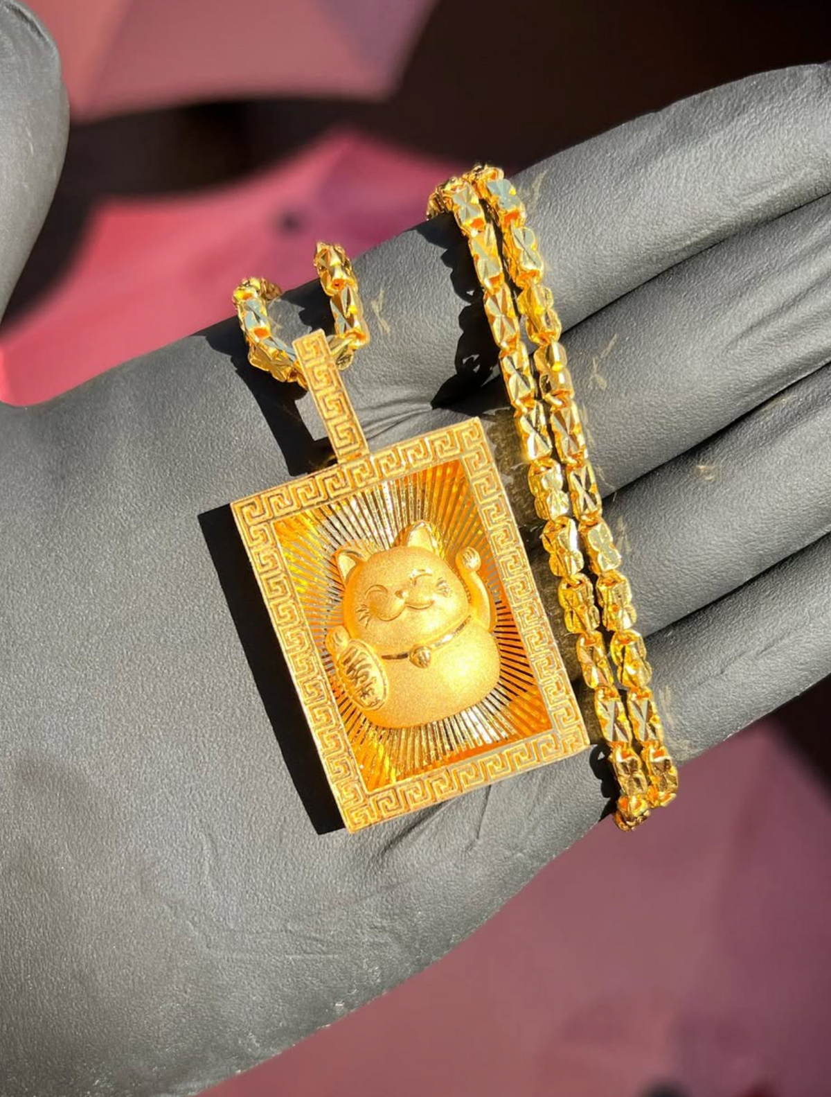 Diamond-Cut Money Cat Rectangular gold pendant, angled view showing the Greek key border carried up the bail