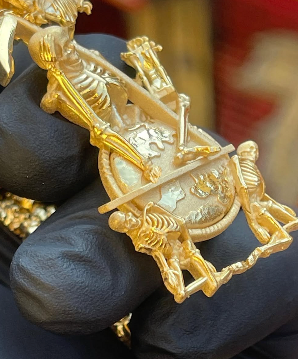 Father Time memento mori gold pendant, angled view showing the pierced openwork composition