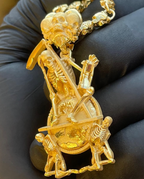 Memento mori gold pendant detail, mirror-polished scythe blade and carved ribcage