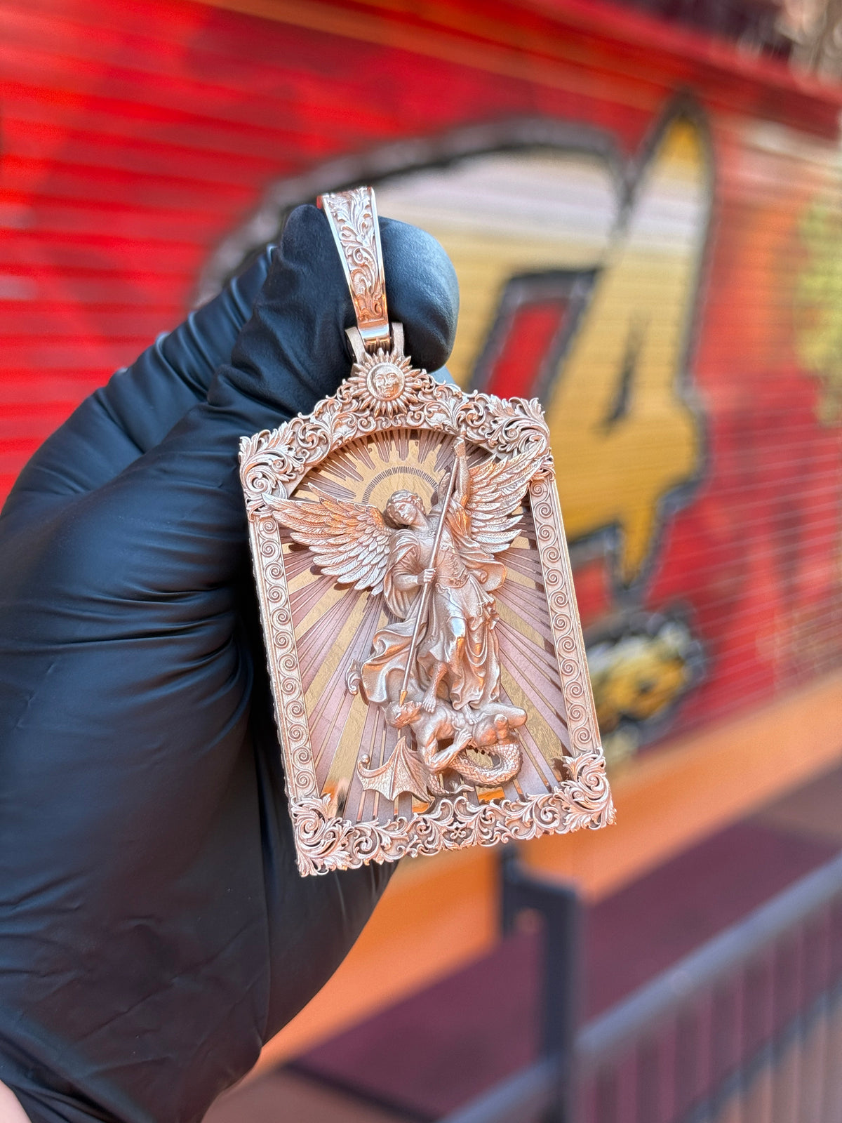 Saint Michael Archangel Portrait V2 gold pendant photographed in hand