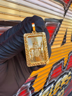 Diamond-Cut Santo Nino filigree border gold pendant photographed in hand