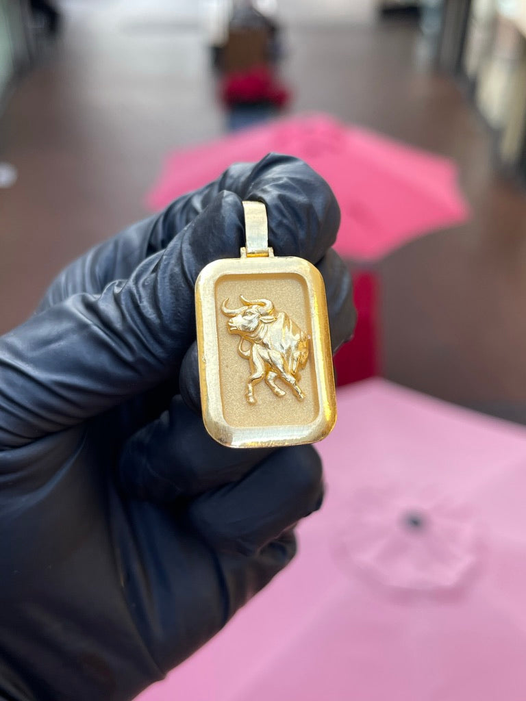 Solid gold Ox rectangular pendant, the zodiac ox in high relief on a satin field inside a polished frame