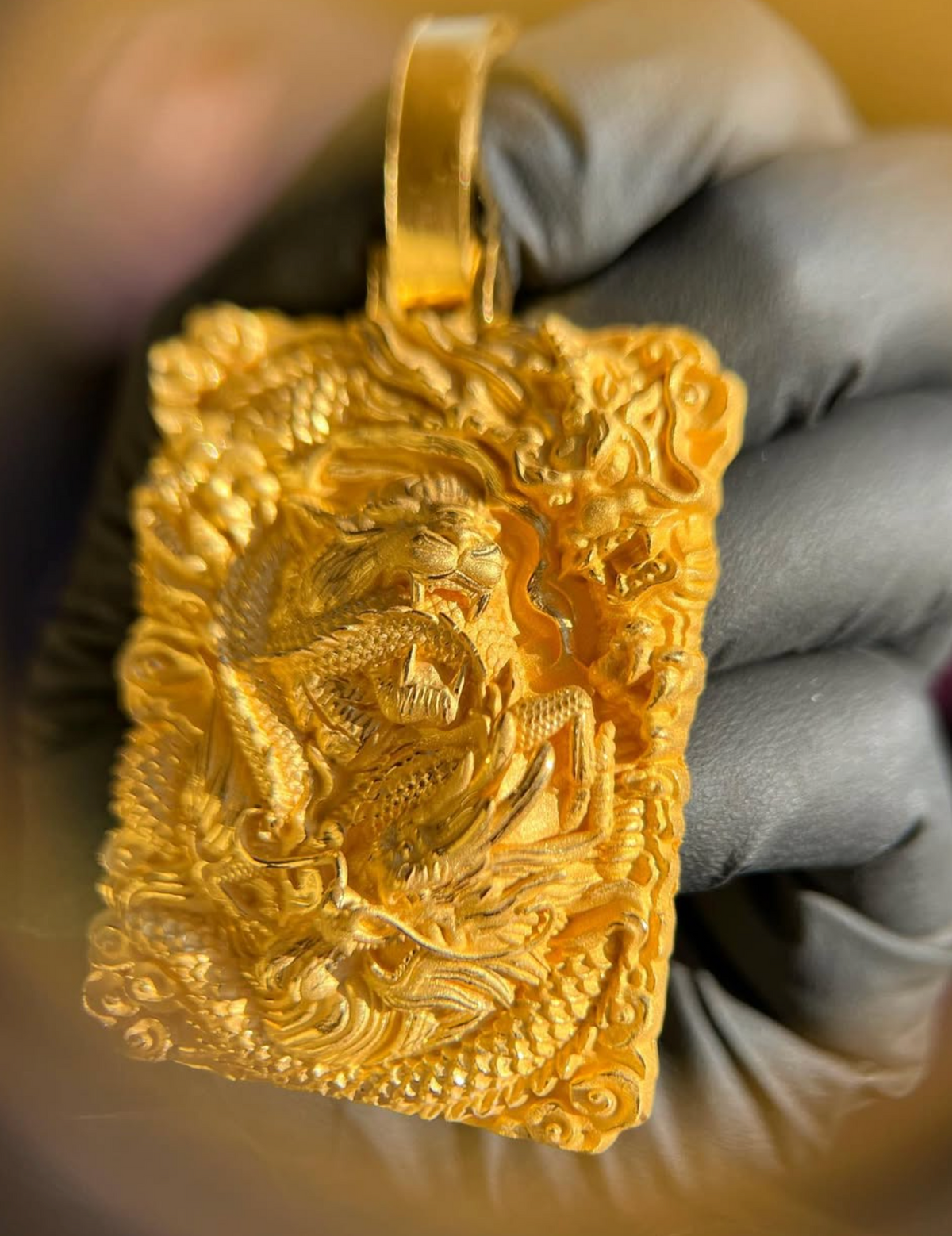 Tiger and Dragon Power gold pendant showing the cloud scrollwork border and satin finish