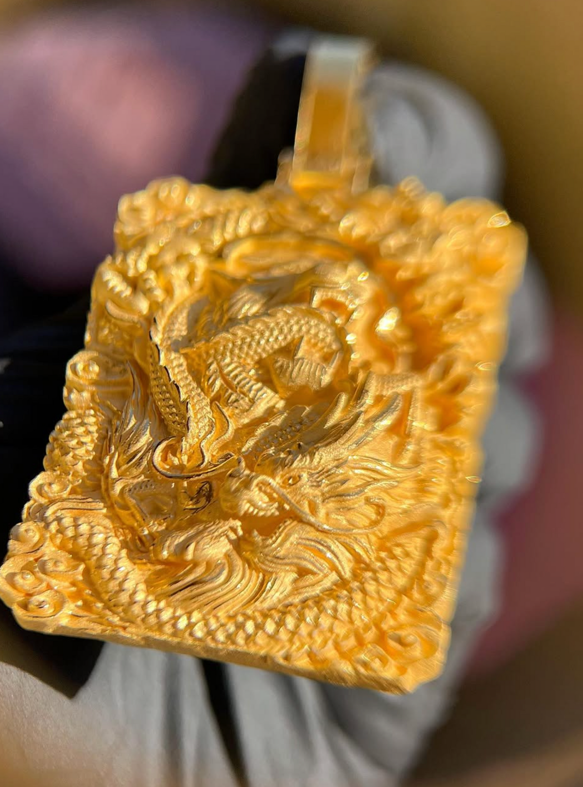 Tiger and Dragon Power gold pendant, angled view showing the plain polished flat bail