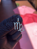 Solid gold Virgo zodiac pendant, the glyph cut as an open letterform with polished bevelled edges