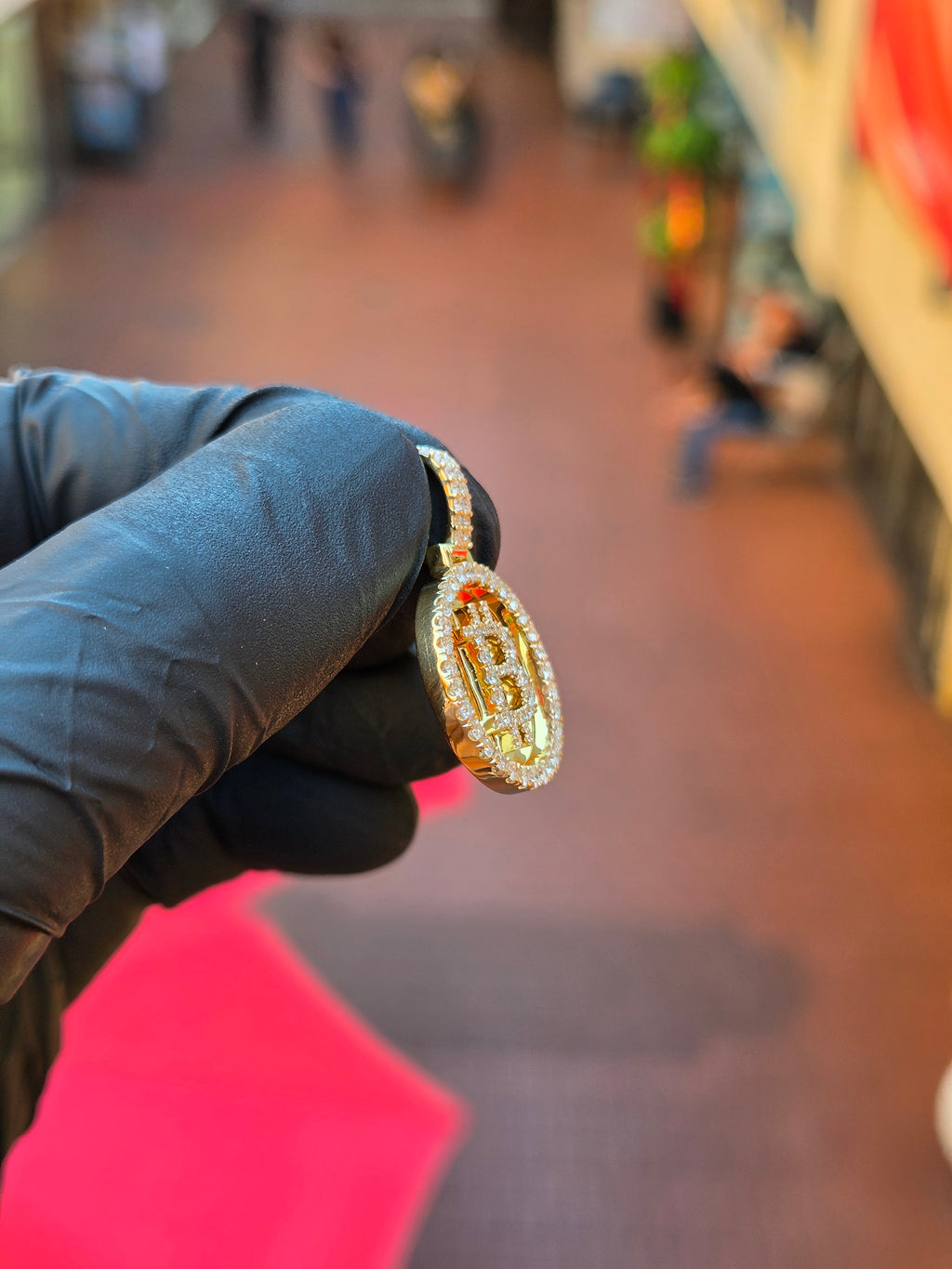 Angled view of the Bitcoin Circular pendant showing the shallow dish and the framing stones standing off the polished rim