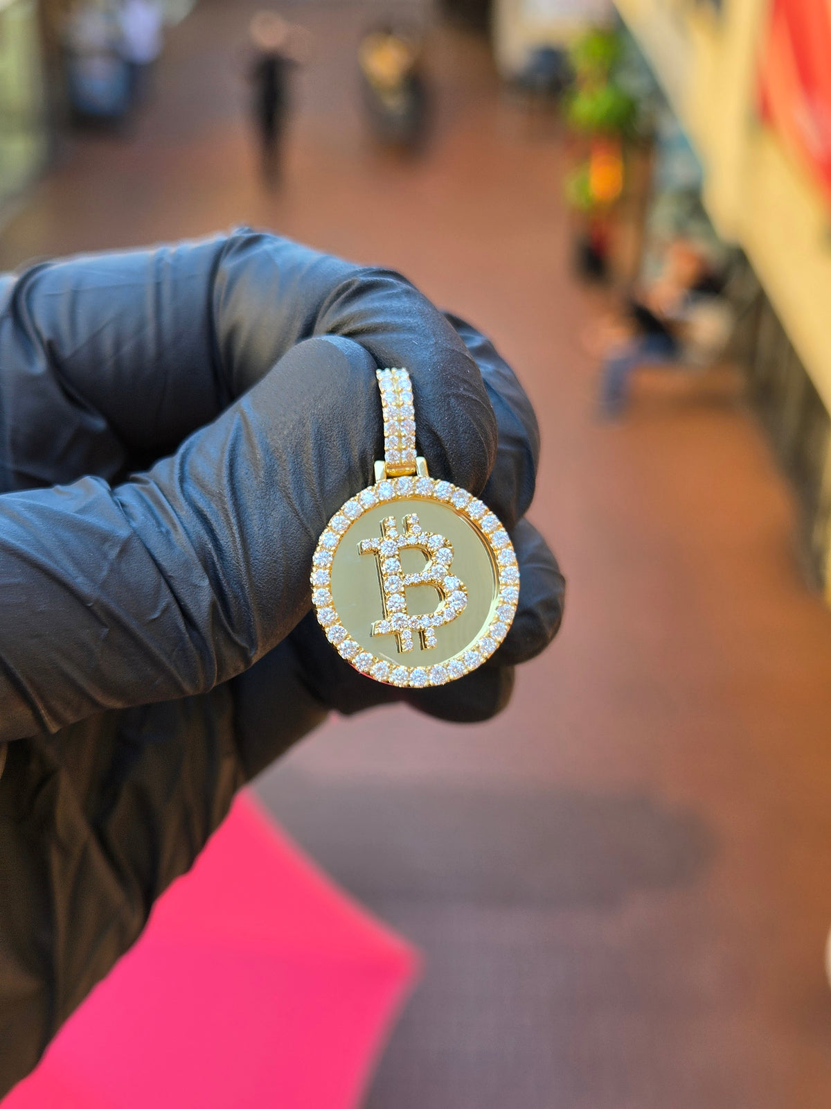 Bitcoin Circular diamond pendant, the raised symbol set with diamonds along the letterform on a plain mirror-polished field