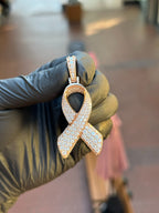 Rose gold Cancer Ribbon Diamond Pendant, the full ribbon face pave-set in round diamonds with a white gold collar and a pave-set bail.