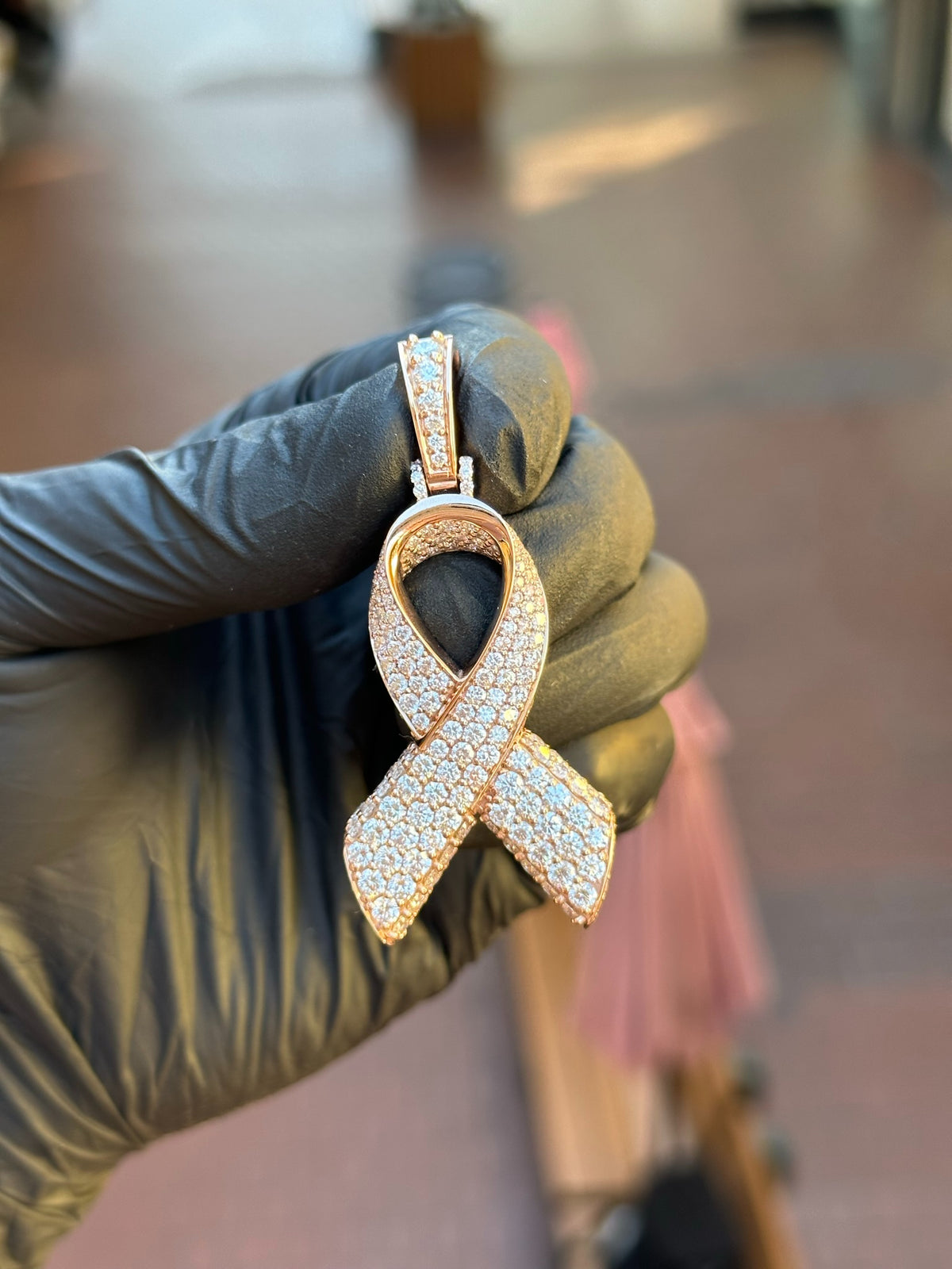 Rose gold Cancer Ribbon Diamond Pendant, the full ribbon face pave-set in round diamonds with a white gold collar and a pave-set bail.