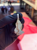 Yellow gold Detailed Praying Hands Diamond Pendant, two hands pressed together in satin gold with the cuff and sleeve pave-set in round diamonds, on a two-row pave bail.