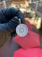 Solid gold Dharma Wheel Circular Pendant, an eight-spoked dharmachakra with each spoke cut as a pillar around a beaded lotus hub, on a plain polished bail.