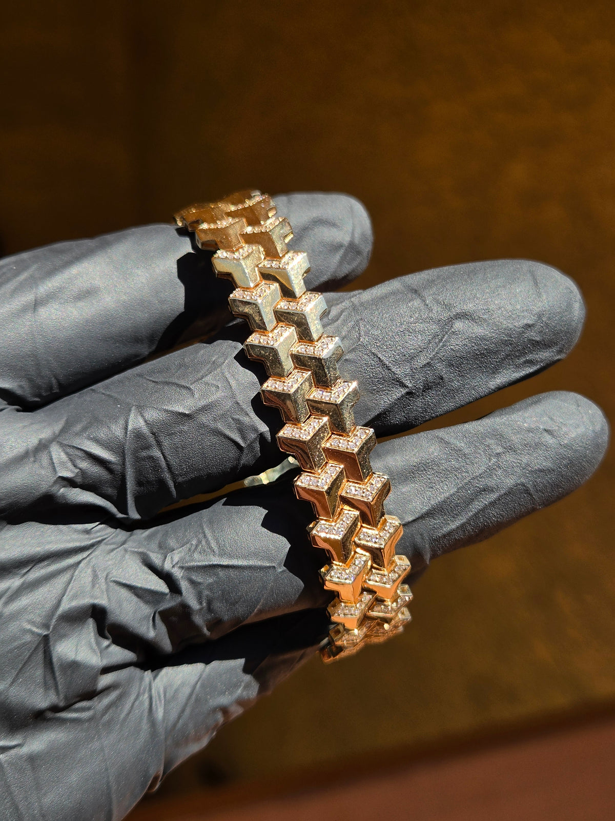 Diamond Armor bracelet in direct sunlight, the pave channels flaring against the polished chevron faces