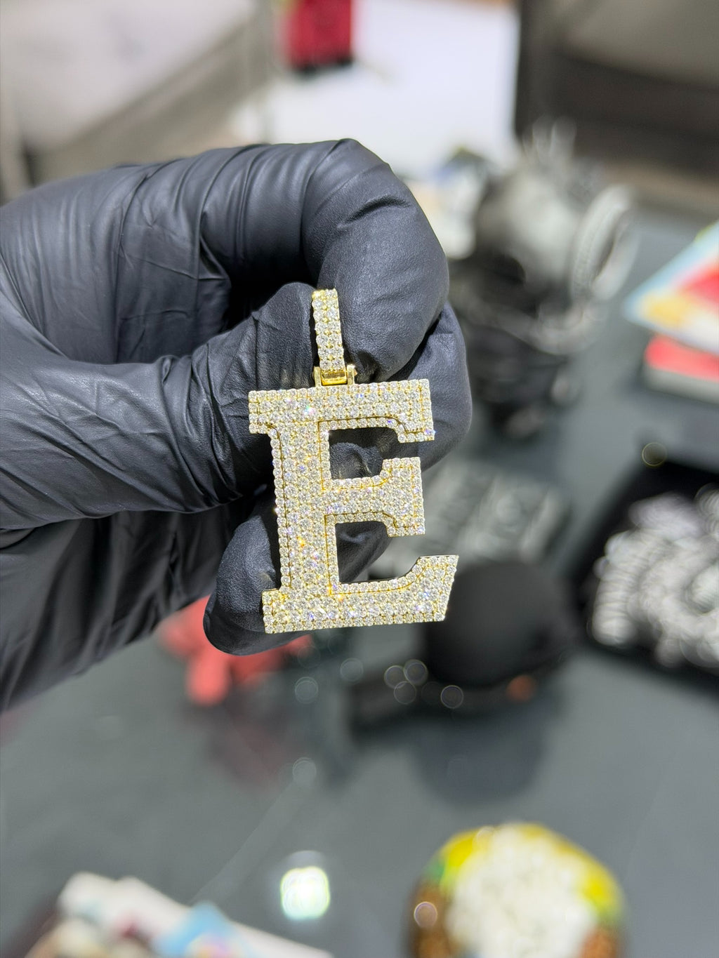 Block E diamond pendant, stepped serif letterform in pave diamonds with a pave bail