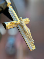 Detailed diamond crucifix pendant, high-relief satin corpus over pave-set arms