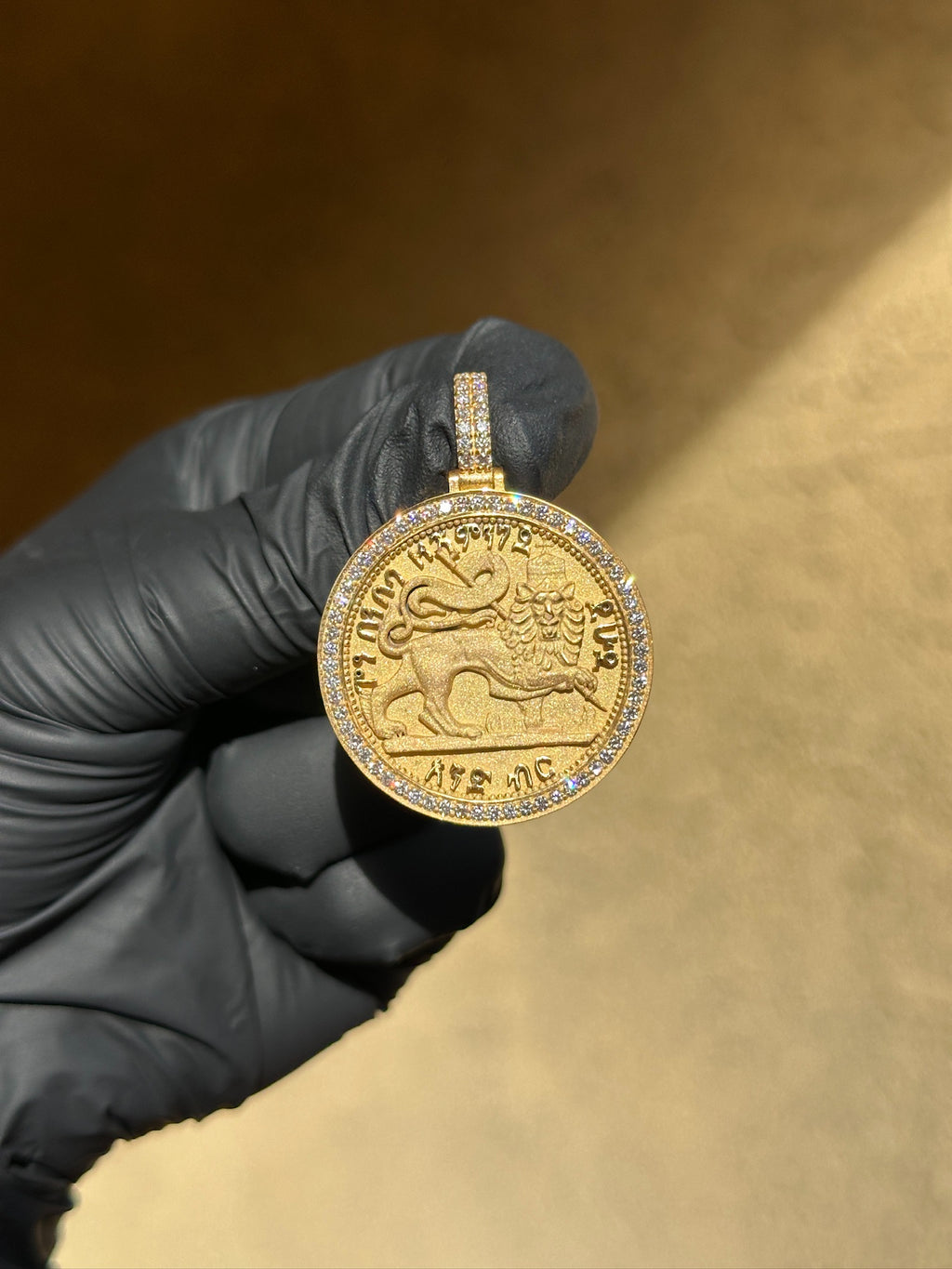 Musa of Mali diamond coin pendant, satin relief face framed by hand-set diamonds
