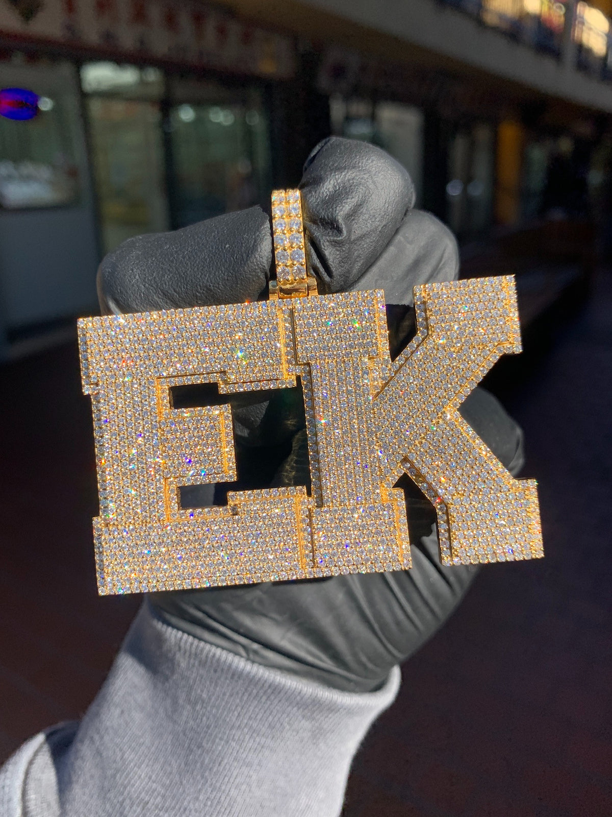 Yellow gold "EK" Diamond Pendant, two large block capitals fully pave-set in round diamonds with a stepped raised border on every face.