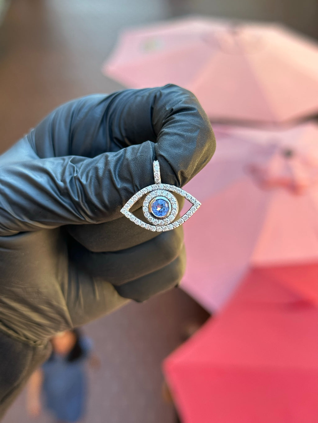 White gold Evil Eye Diamond Pendant, an open diamond-traced almond frame around a bezel-set synthetic blue centre stone with a pave halo.