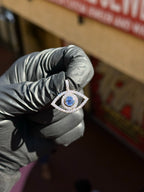 Evil Eye Diamond Pendant in daylight, showing the field cut away between the pave halo and the diamond outline.