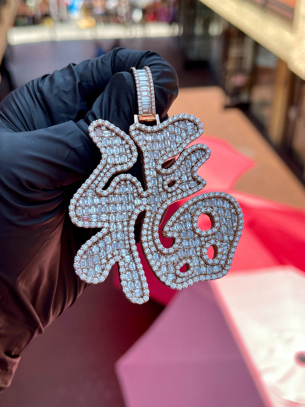 Daylight view of the Fu (Lucky) Diamond Pendant showing the full stroke structure of the character and the baguette-set bail above it.